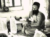 A Jerusalem scribe writes out one of the five Holy Books of Moses in Hebrew. An early photograph.